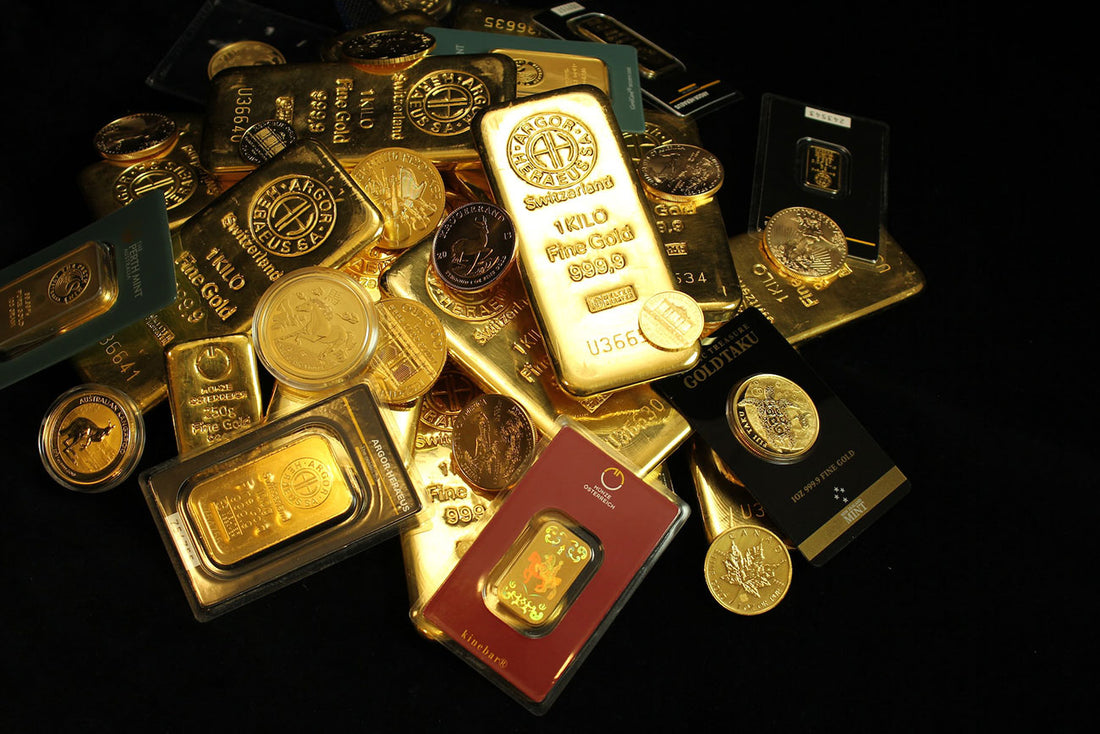 A large assortment of gold bars and coins against a black background