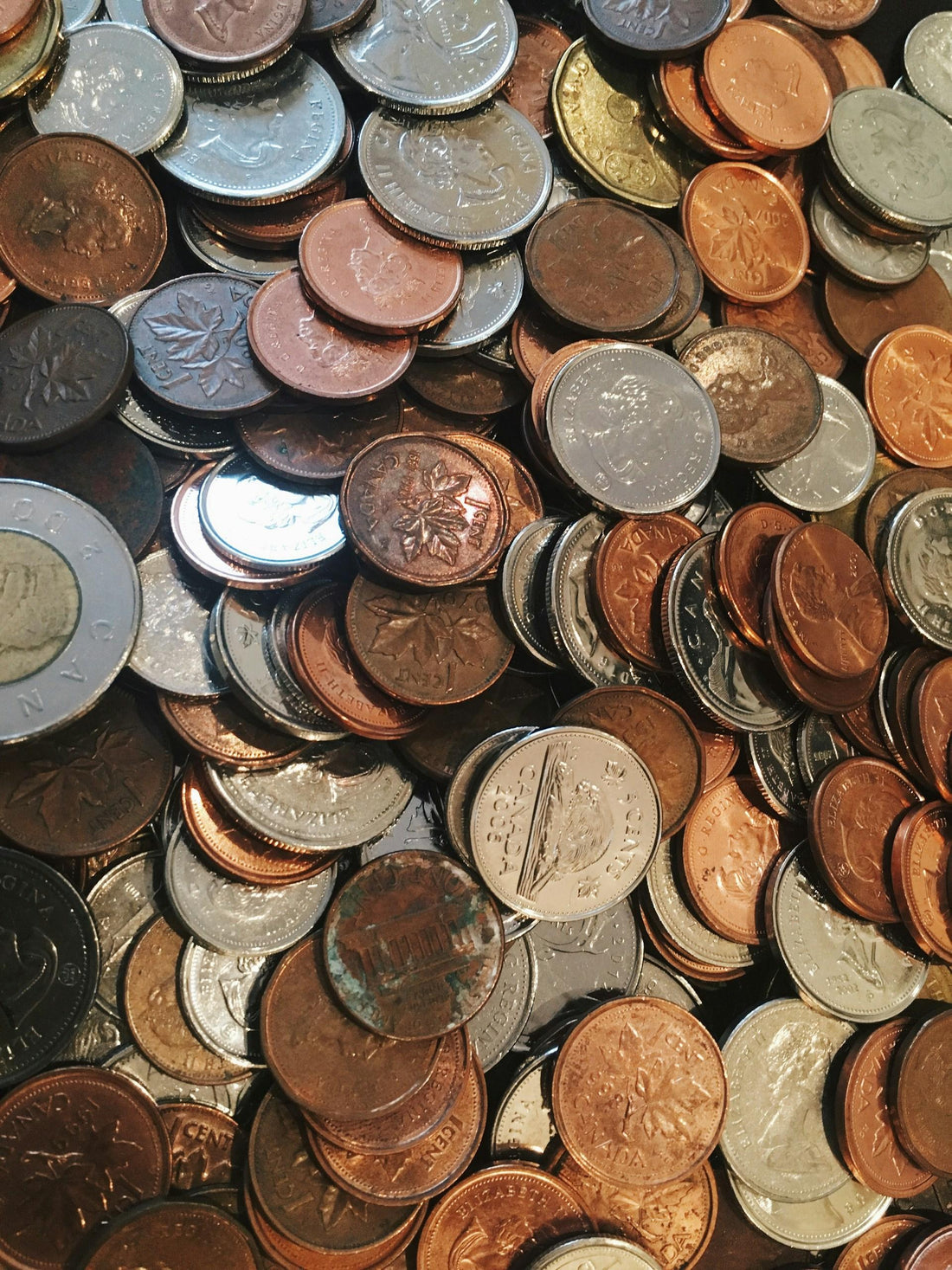 An unsorted collection of circulated Canadian coins